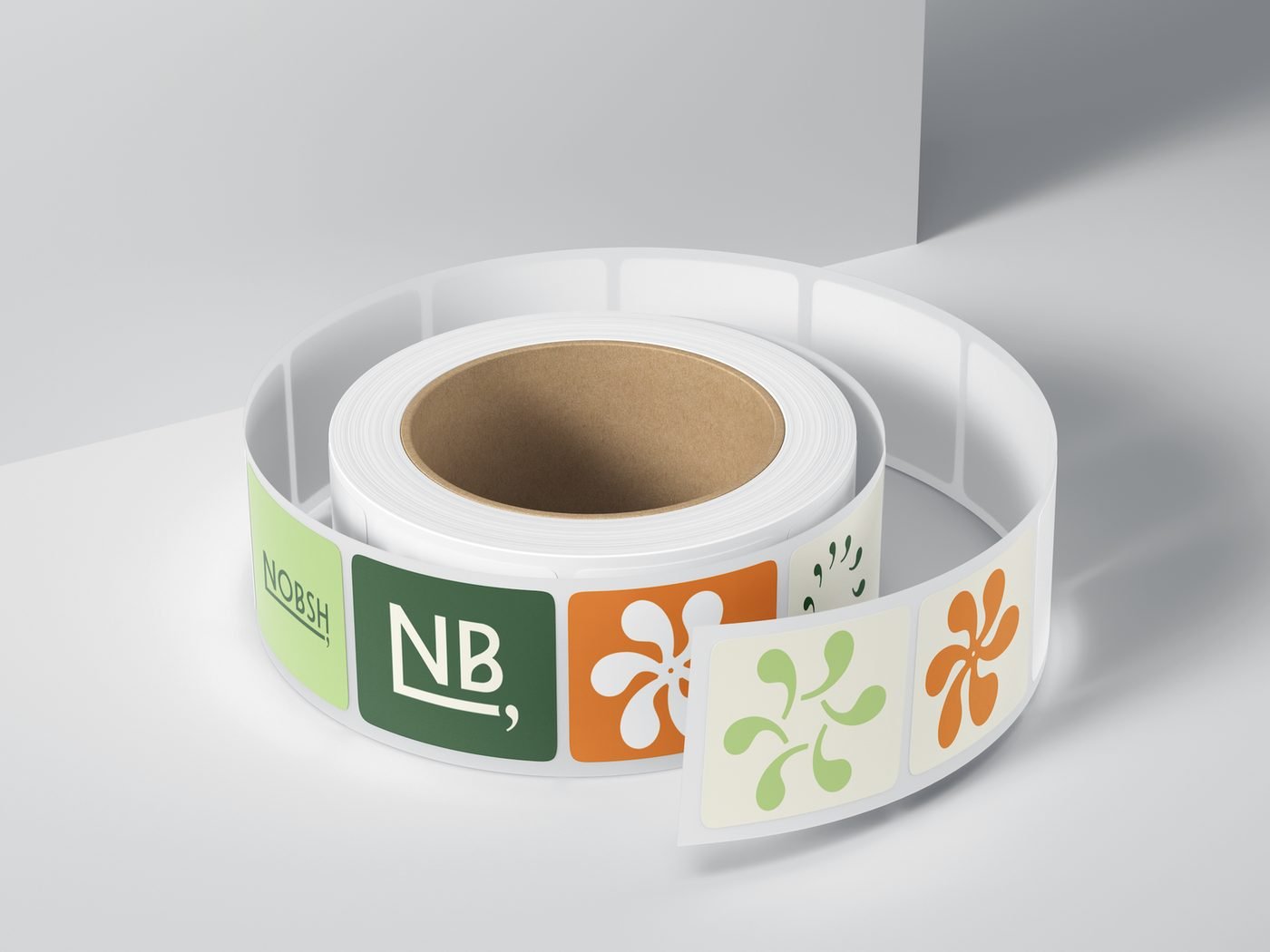 Roll of brand stickers in green and orange